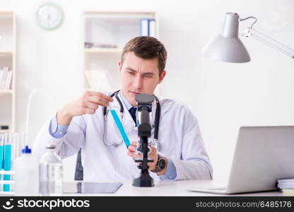 Male doctor looking at lab results in hospital