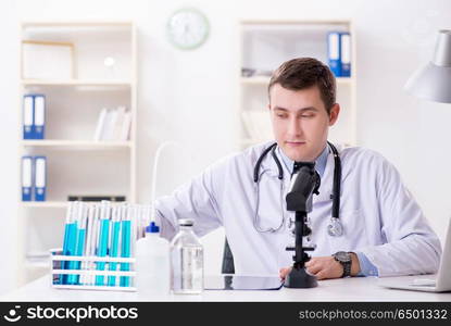 Male doctor looking at lab results in hospital