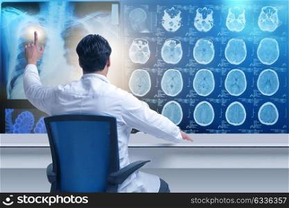 Male doctor looking at MRI scans