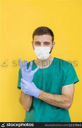 male doctor mask putting sterile gloves