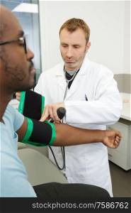 male doctor measuring blood pressure of patient
