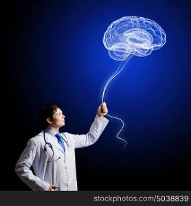 Male doctor neurologist. Image of young doctor neurologist against dark background