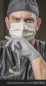 Male Doctor or Nurse Wearing Scrubs, Protective Face Mask and Goggles.