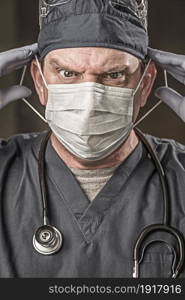 Male Doctor or Nurse Wearing Scrubs, Protective Face Mask and Goggles.