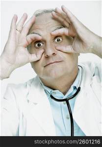 Male doctor pretending to wear glasses