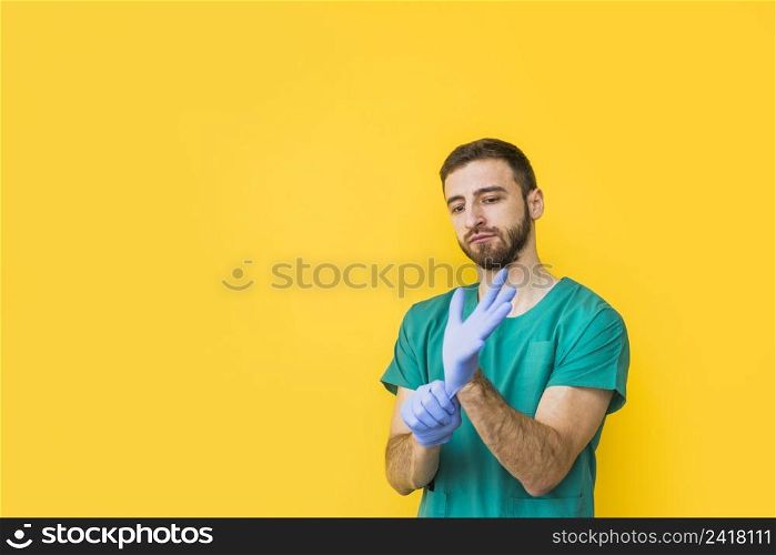 male doctor putting sterile gloves