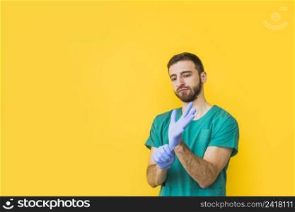 male doctor putting sterile gloves