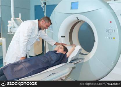 male doctor reassuring female patient before computed tomography scan
