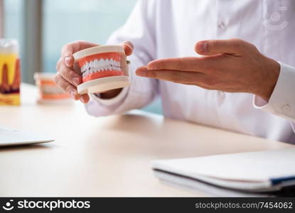 Male doctor stomatologist working in the clinic 