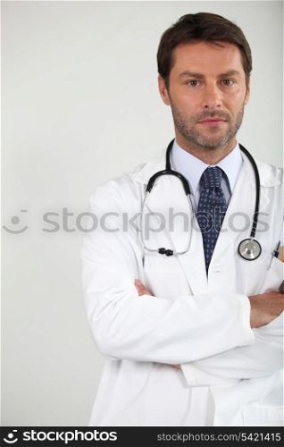 Male doctor stood arms folded