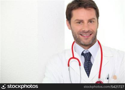 Male doctor stood smiling