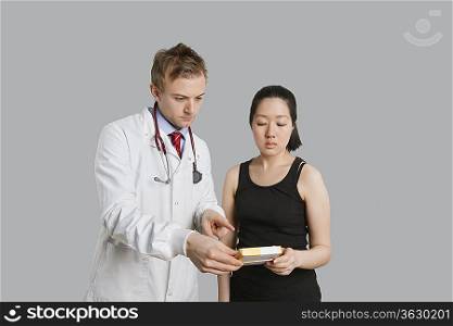 Male doctor suggesting medication to female patient