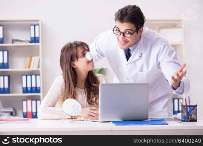 Male doctor talking to patient with nose operation surgery