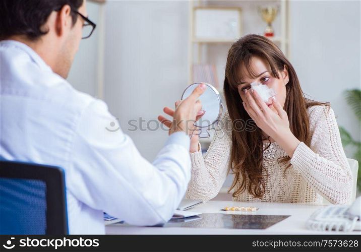 Male doctor talking to patient with nose operation surgery. The male doctor talking to patient with nose operation surgery