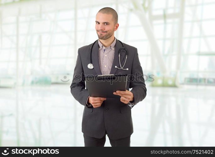 male doctor thinking with his notes, at the hospital