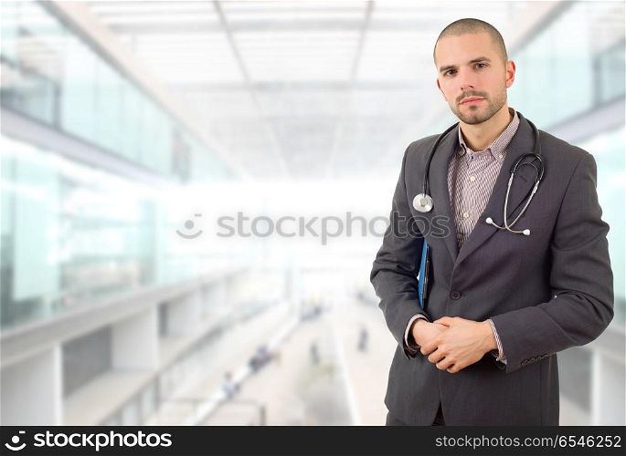 male doctor thinking with his notes, at the hospital. doctor thinking