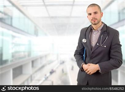 male doctor thinking with his notes, at the hospital. doctor thinking