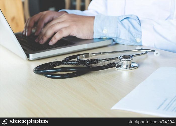 Male doctor using a laptop