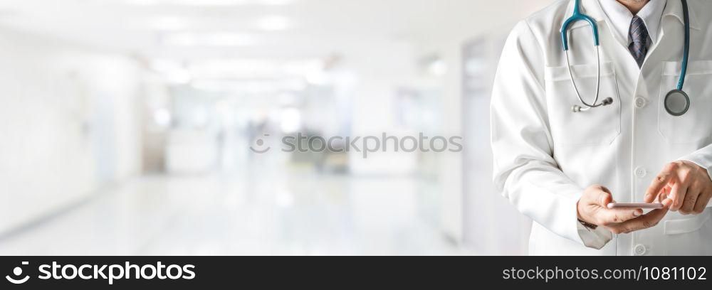 Male doctor using mobile phone at hospital. Medical healthcare and doctor service.