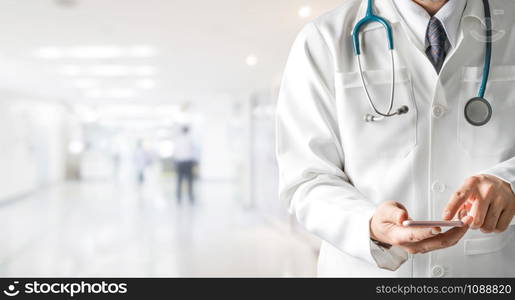 Male doctor using mobile phone at hospital. Medical healthcare and doctor service.