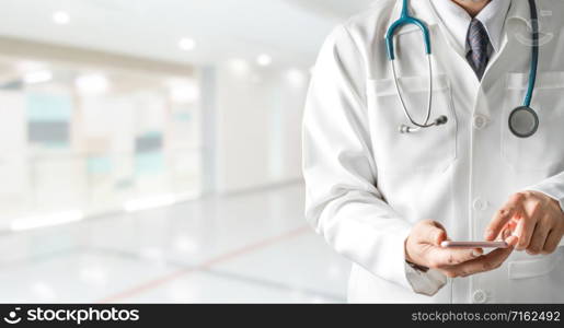 Male doctor using mobile phone at hospital. Medical healthcare and doctor service.