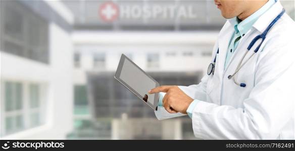 Male doctor using tablet computer at hospital. Medical research staff and doctor service.