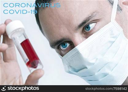 Male doctor wearing face mask with Coronavirus COVID-19 blood sample. Picture with text.