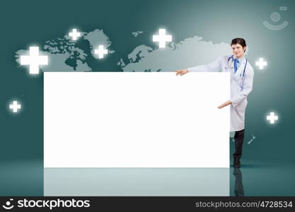 Male doctor with banner. Young male doctor leaning upon blank banner. Place for text