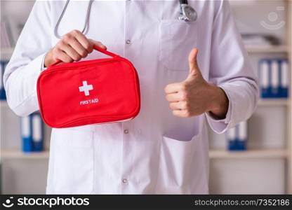 Male doctor with first aid bag 