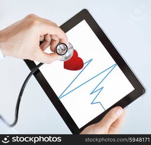 male doctor with stethoscope and tablet pc listening to heart beat. doctor with stethoscope and tablet pc