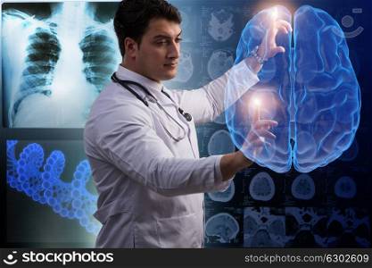 Male doctor with the brain in medical concept