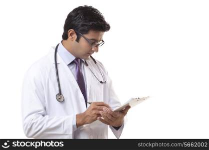 Male doctor writing on clipboard over white background