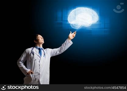 Male doctor. Young male doctor touching digital lightened image