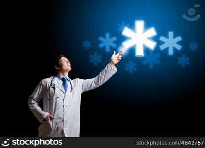 Male doctor. Young male doctor touching digital lightened image