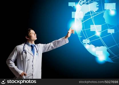 Male doctor. Young male doctor touching icon of media image