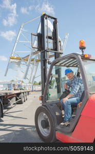 Male driver in forklift truck