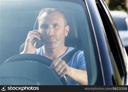 male driver using his phone while driving