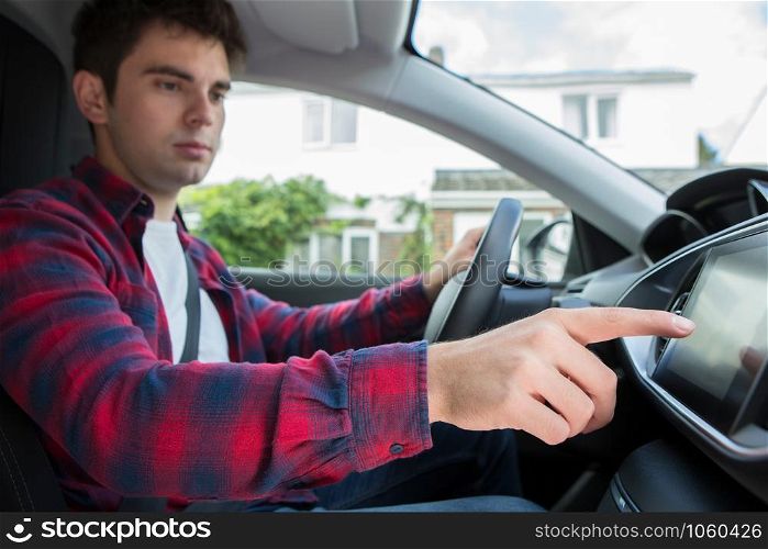 Male Driver Using Touchscreen In Car