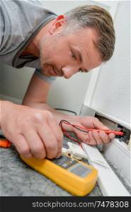 male electrician is checking current