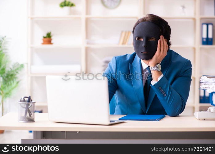 Male employee in the office in industrial espionage concept   