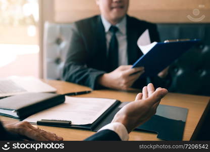 Male employee is describing his work history for the job interview officer.