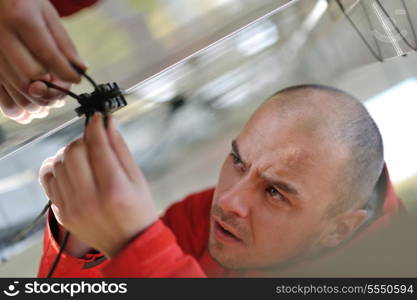 Male engineer at work place, solar panels plant industy in background