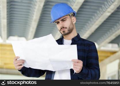 male engineer looking at plans