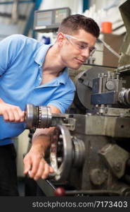 Male Engineer Operating Lathe In Factory