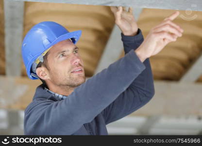 male engineer pointing at ceiling