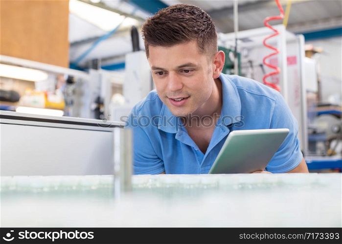 Male Engineer With Digital Tablet Working In Bottle Capping Factory