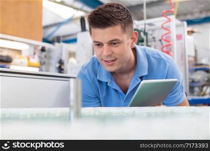 Male Engineer With Digital Tablet Working In Bottle Capping Factory