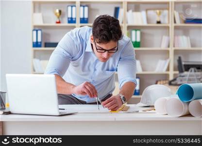 Male engineer working on drawings and blueprints