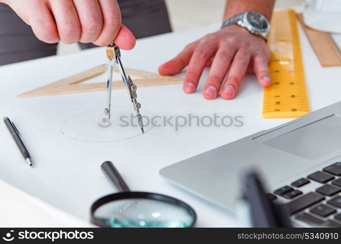 Male engineer working on drawings and blueprints