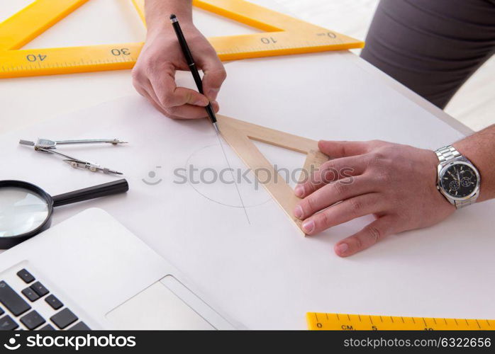 Male engineer working on drawings and blueprints